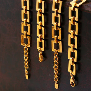Gold geometric link bracelet with adjustable chain and lobster clasp closure.