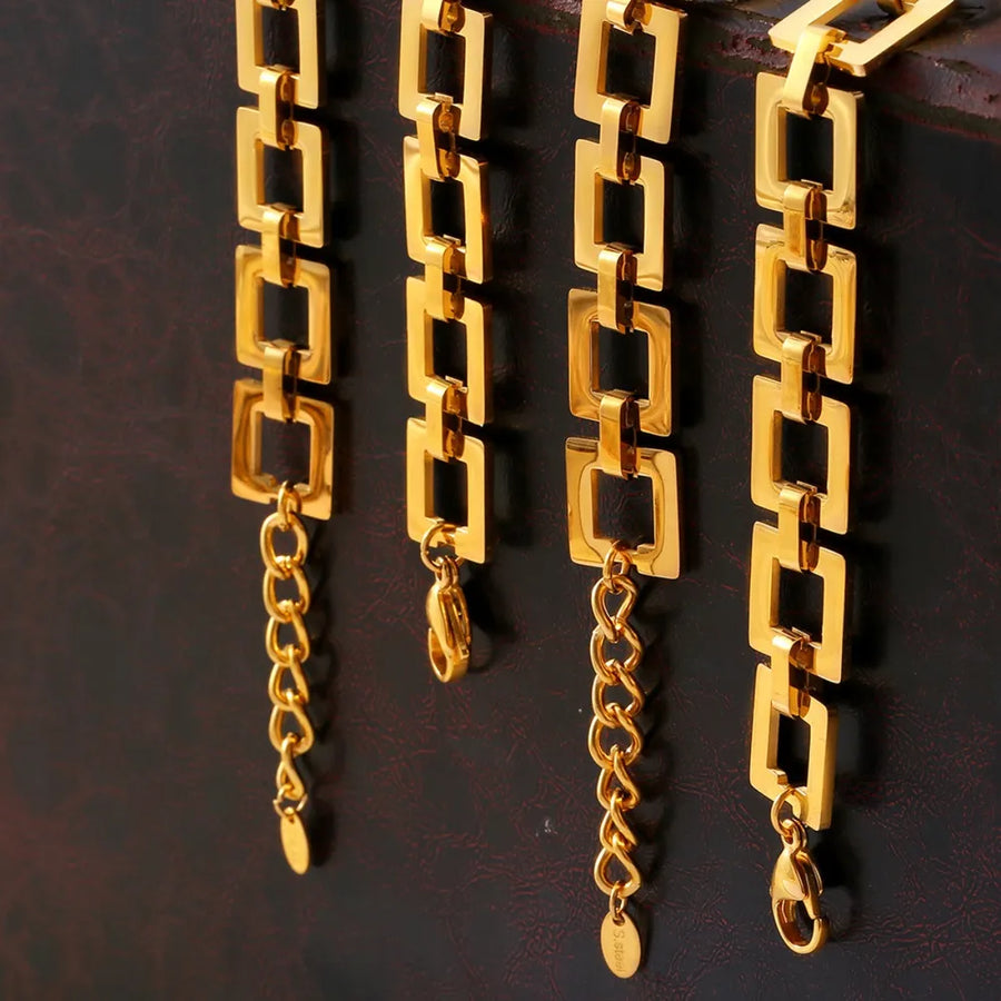 Gold geometric link bracelet with adjustable chain and lobster clasp closure.