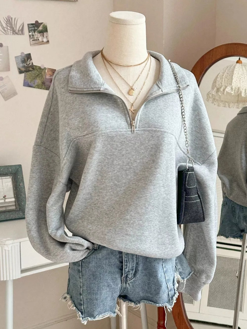 sweatshirt in heather grey featuring zipper and relaxed fit