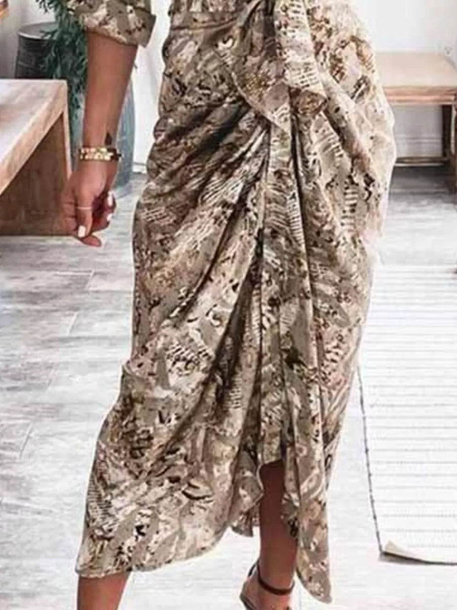 Elegant tie-waist midi dress in a neutral abstract print with a draped skirt and side slit.