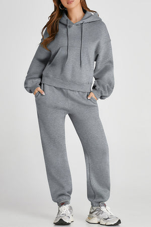 Gray relaxed fit loungewear set with hoodie and drawstring pants, featuring pockets.