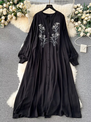 Black embroidered floral maxi dress with tie neck and balloon sleeves.