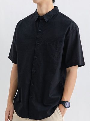 Men's black short sleeve buttoned cotton shirt with chest pocket.