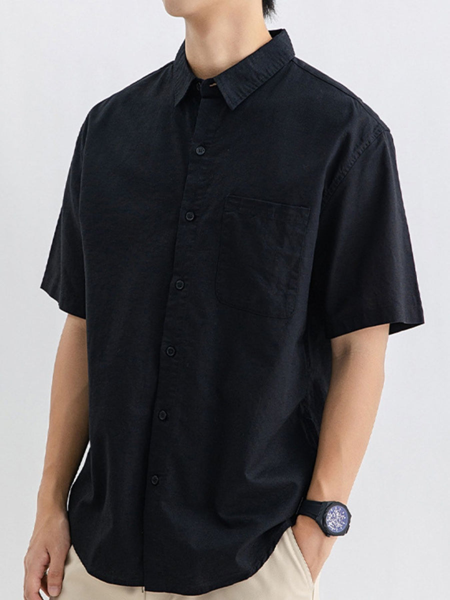 Men's black short sleeve buttoned cotton shirt with chest pocket.