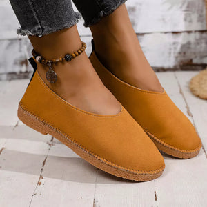 Yellow suede round toe comfort flats with contrast stitching and a beaded anklet.