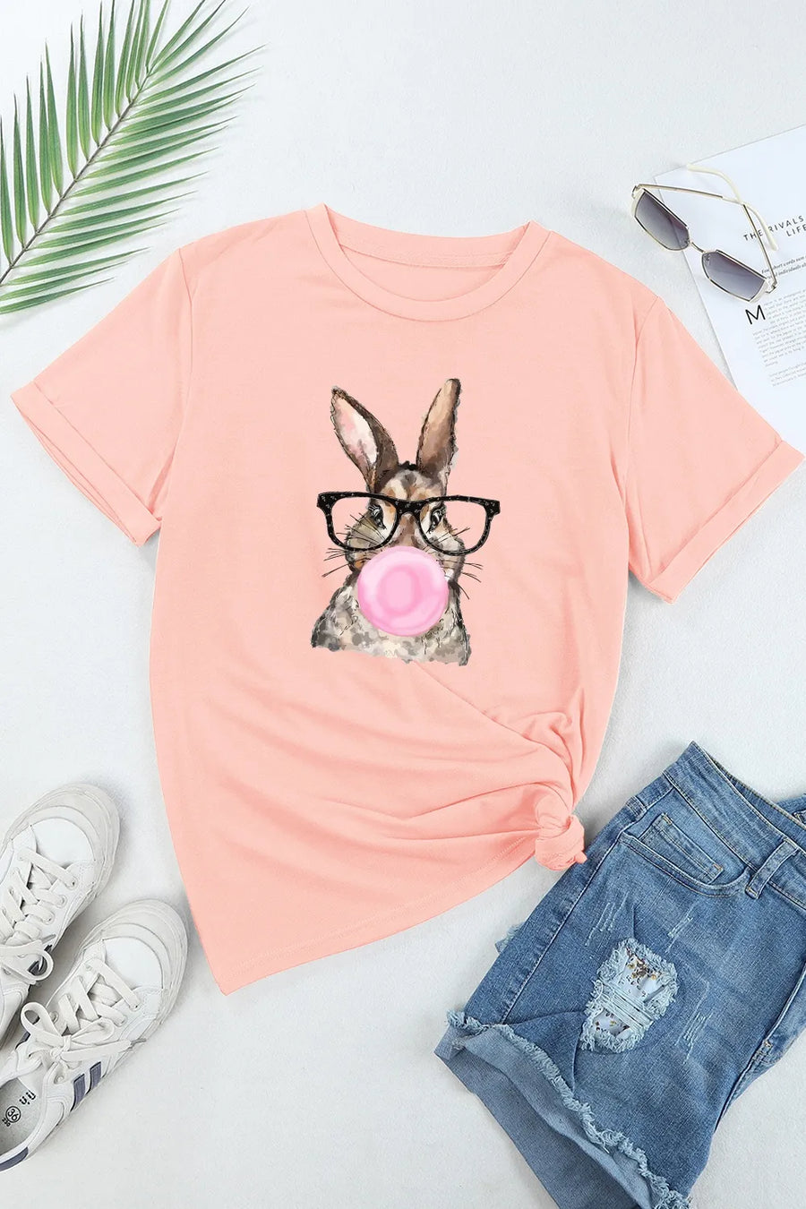 Pink t-shirt with a watercolor bunny wearing glasses and blowing bubblegum graphic.