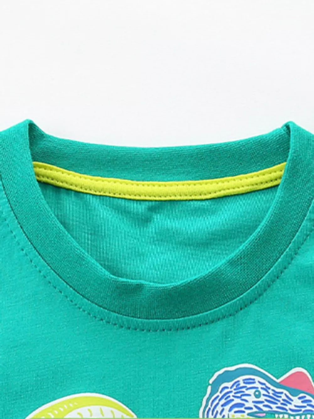 Green cotton crew neck t-shirt with yellow trim detail and dinosaur graphic.