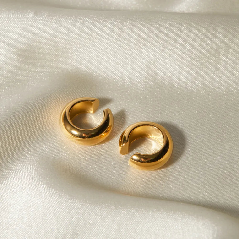 Sculptural gold-tone ear cuff duo with a contemporary clip design.