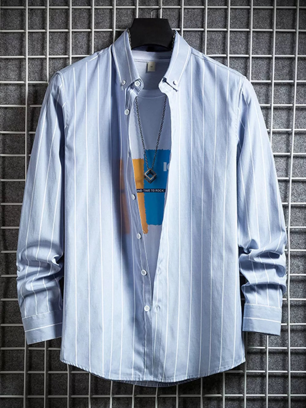 Blue striped long sleeve button-down shirt layered over a graphic tee.