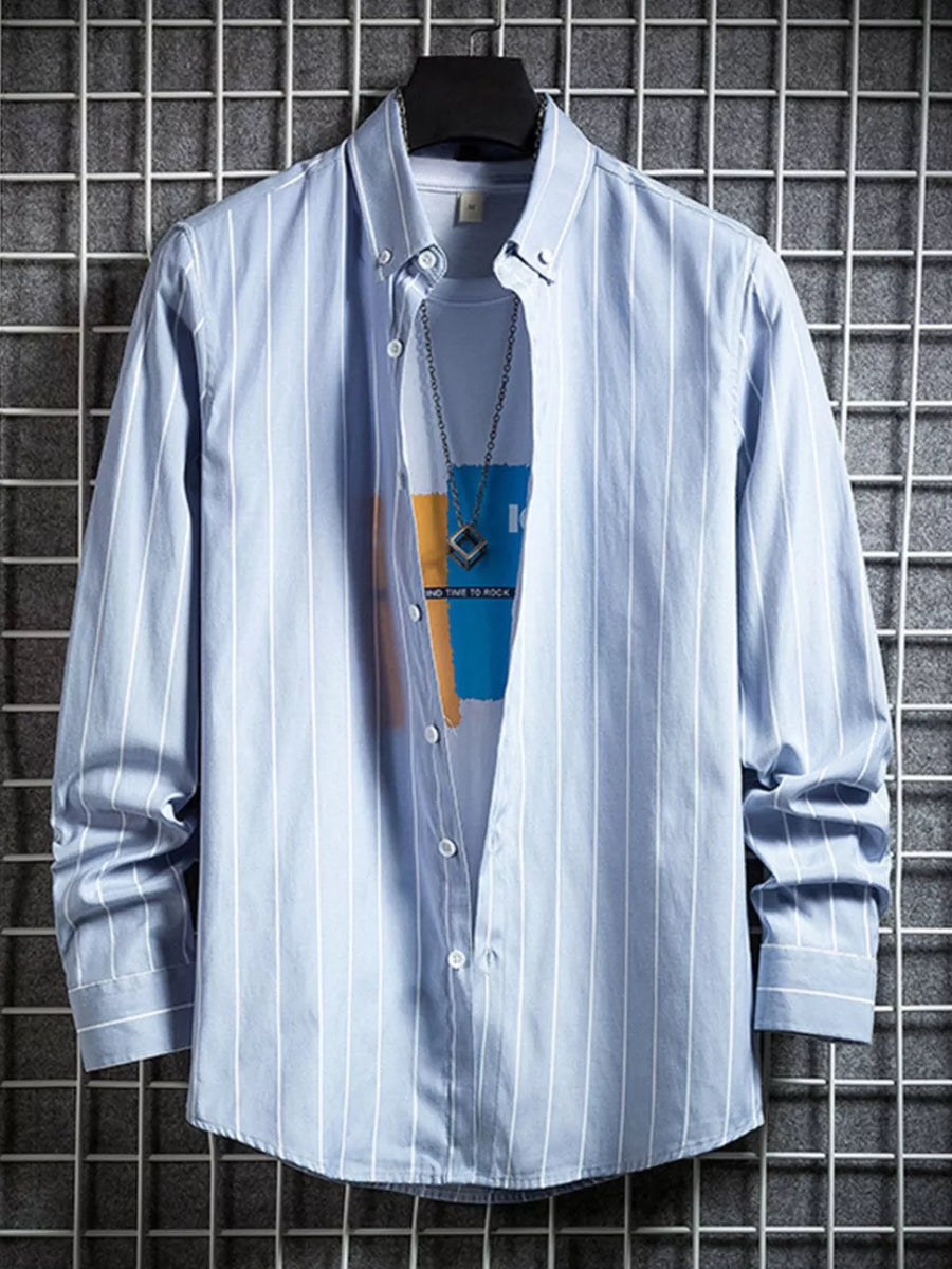 Blue striped long sleeve button-down shirt layered over a graphic tee.