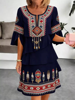 Navy boho tiered dress with embroidered neckline, sleeves, and hem.
