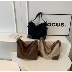 handbag in black featuring patchwork construction and relaxed fit