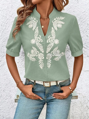 Green embroidered notched blouse with cuffed sleeves and V-neck.