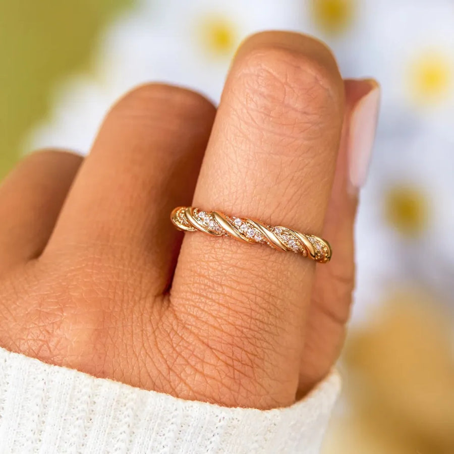 Gold twisted band ring with pave zirconia details on sterling silver.
