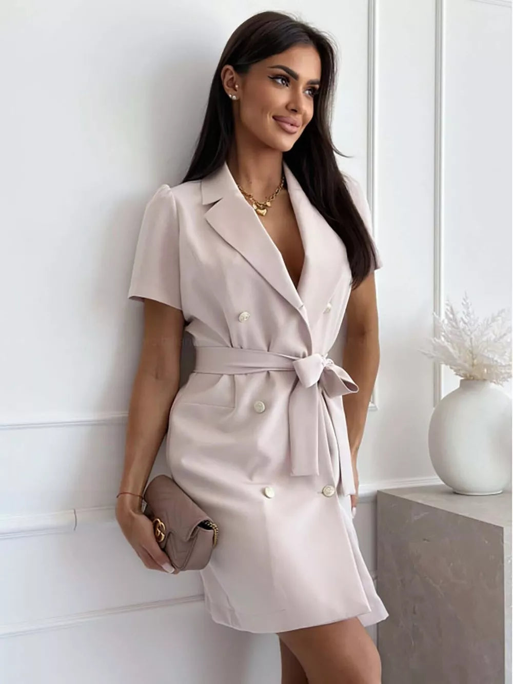 Blush pink belted blazer dress with double-breasted buttons and short sleeves.