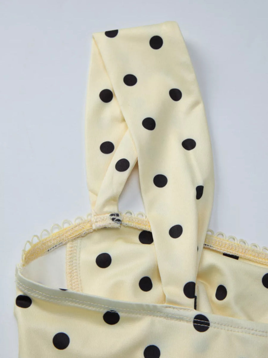 Pastel yellow polka dot tank top with sweetheart neckline and lace trim detail.