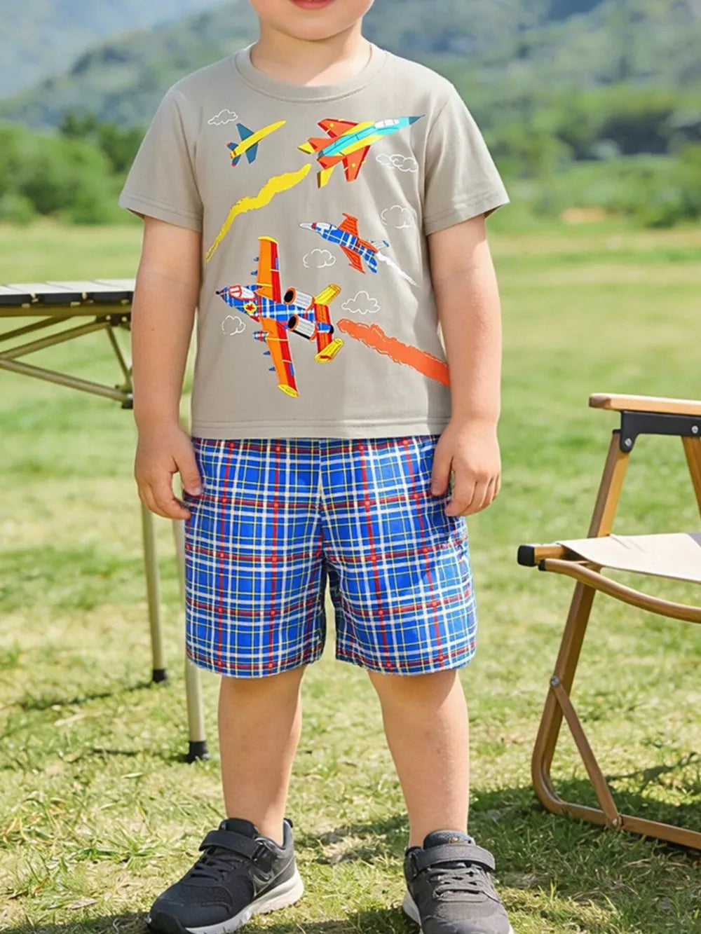 Toddler boys' tan t-shirt with airplane graphic and blue plaid shorts.