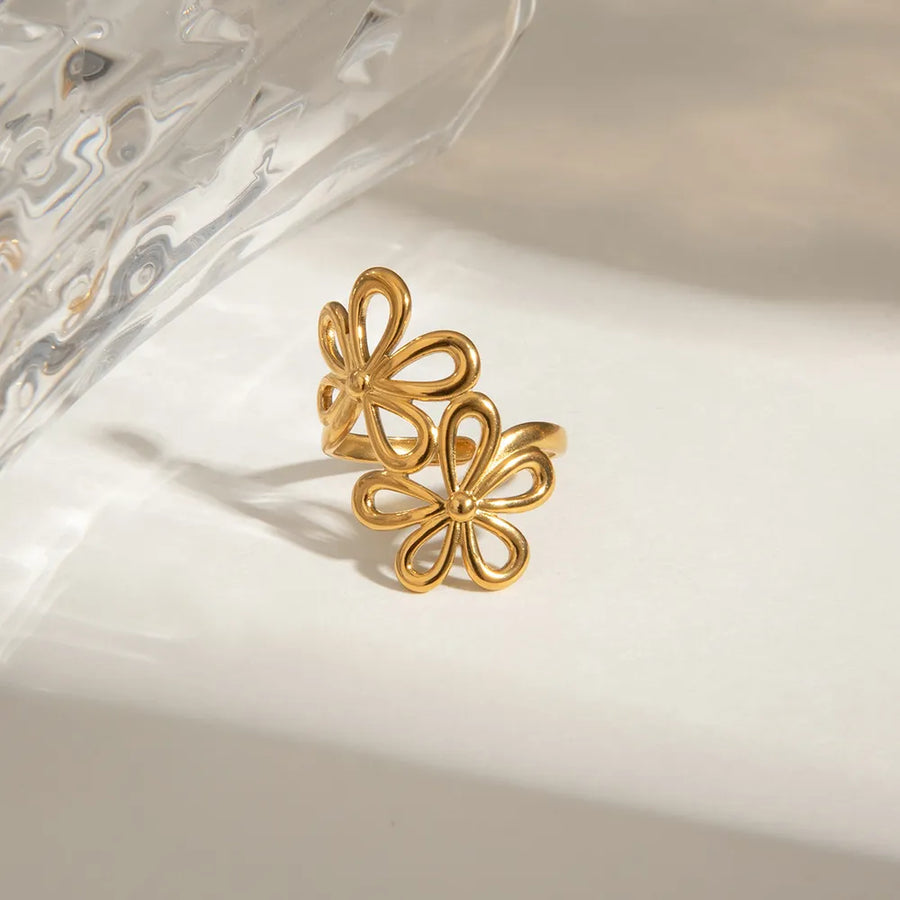 Gold ring featuring double bloom design and floral