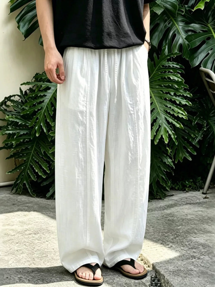 White wide-leg sweatpants with drawstring and subtle vertical stitching detail.