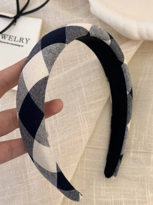 Padded headband with black and white gingham pattern.