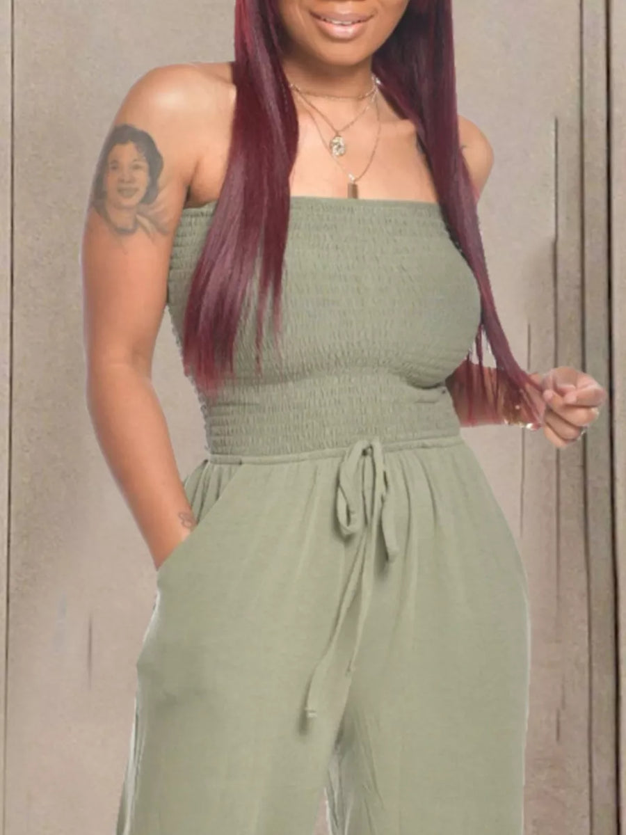 Olive green smocked strapless jumpsuit with drawstring waist and wide legs