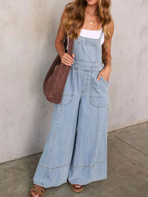 Light wash denim overalls with wide legs and front pockets.