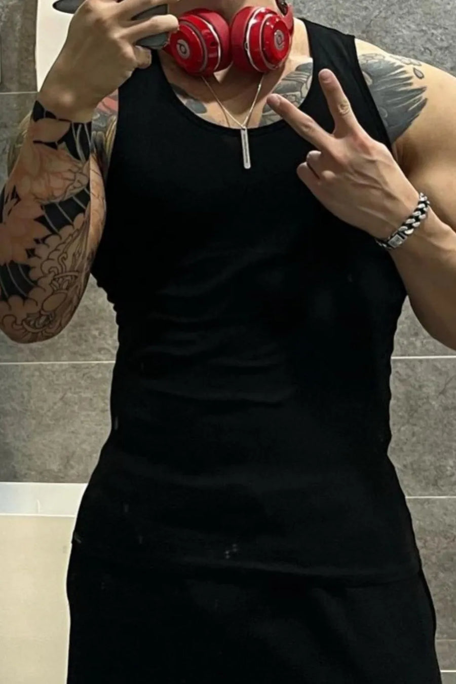 Black ribbed cotton muscle tank top with crew neck.
