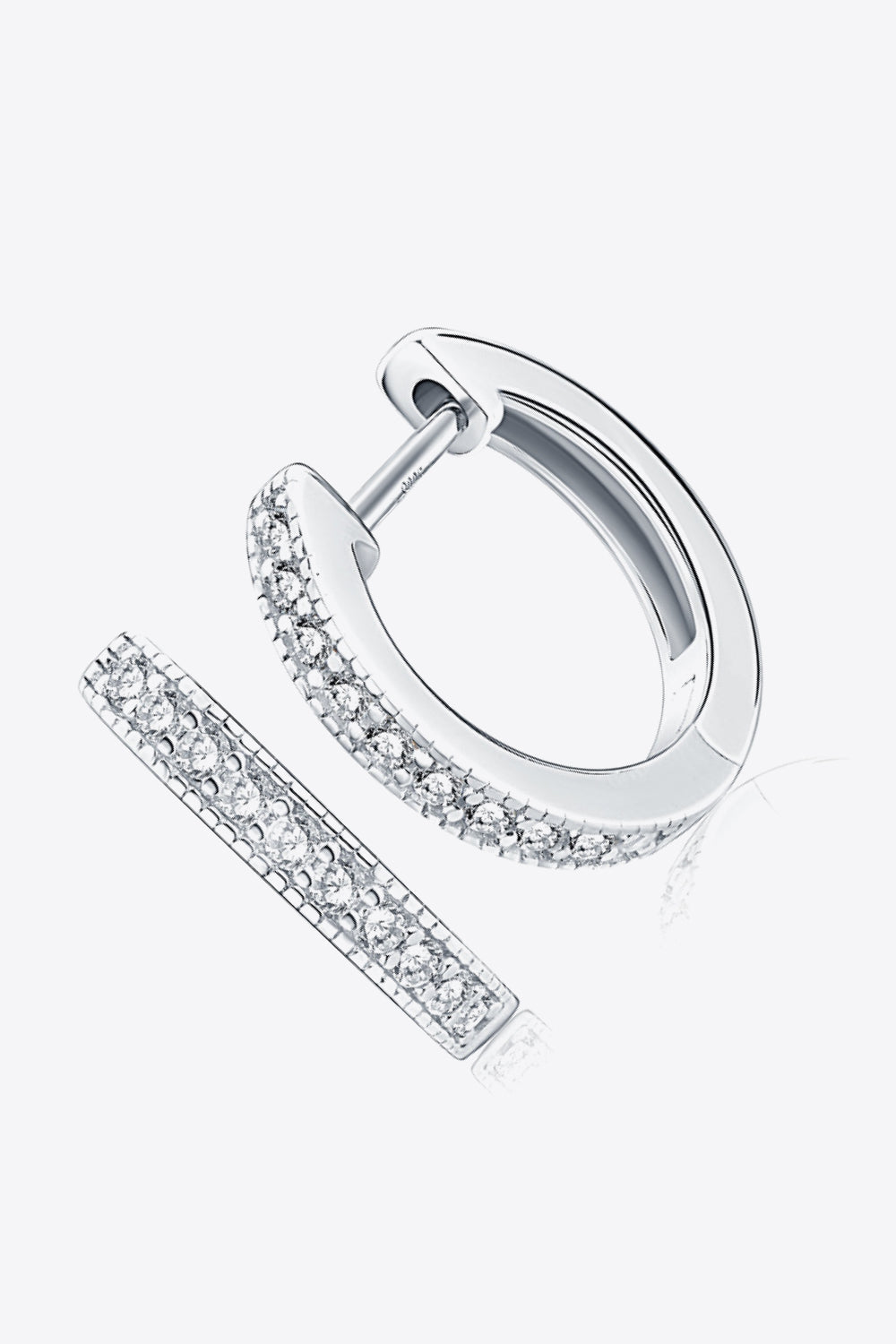 Silver pave-set huggie hoop earrings with sparkling stones.