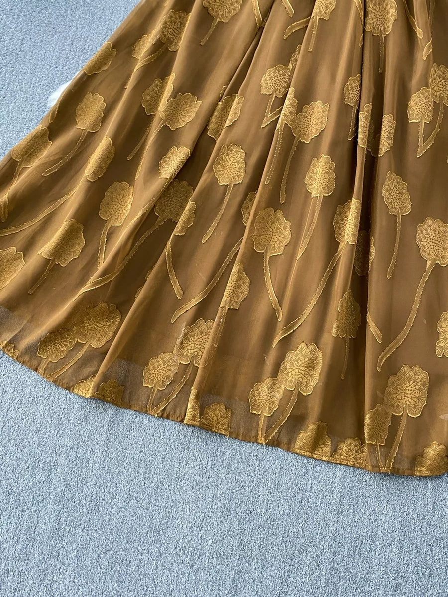 Brown chiffon maxi dress with gold floral embroidery and a belted waist.
