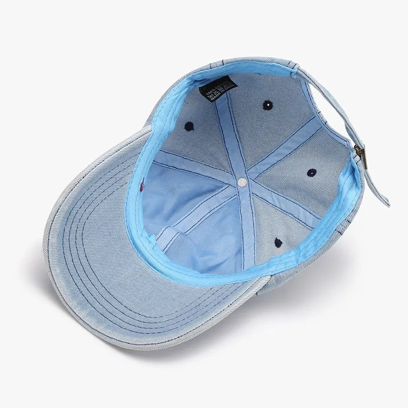 Light denim baseball cap with shredded details and blue lining.