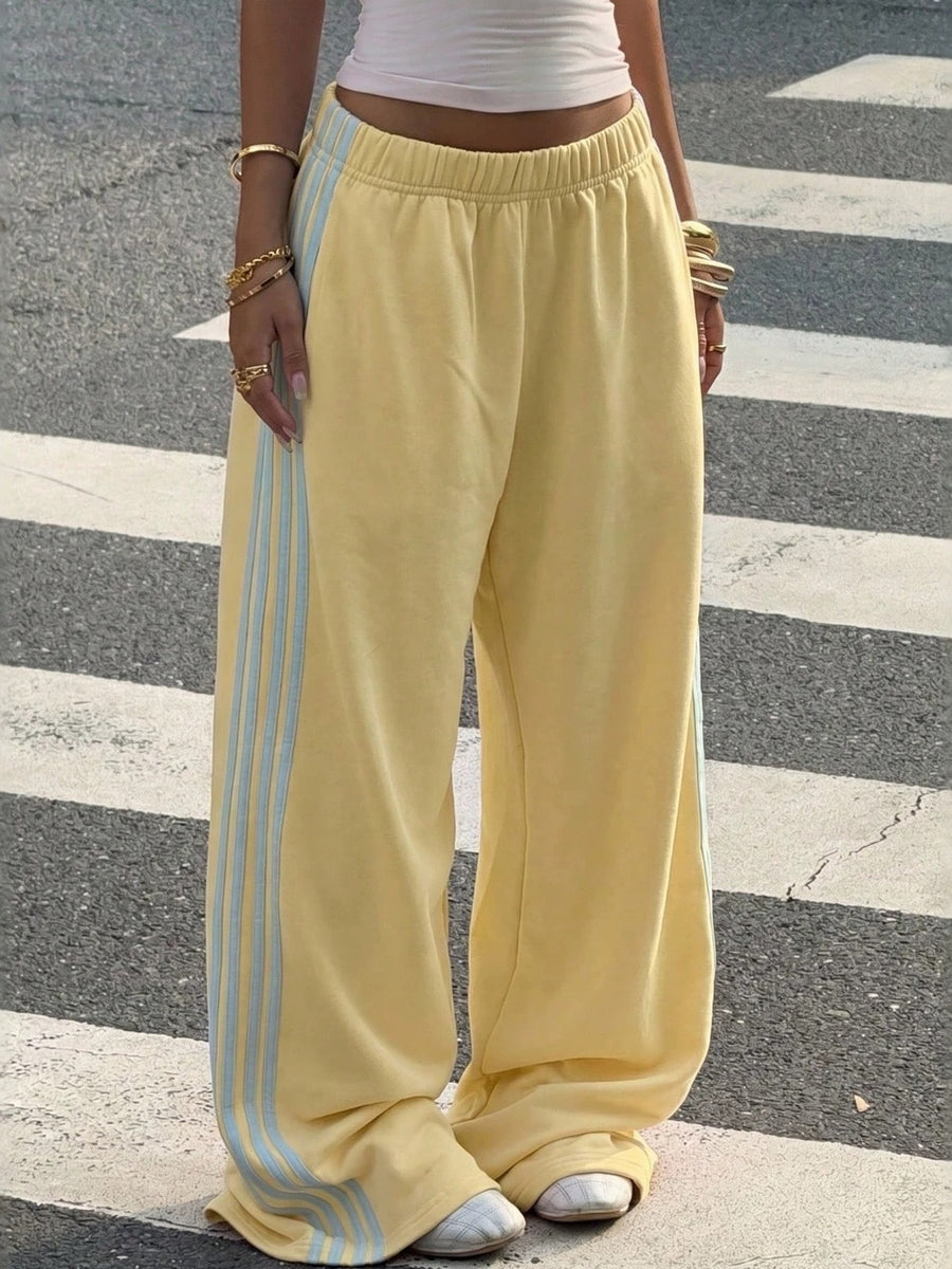 track pants in yellow featuring high-waisted and wide-leg fit