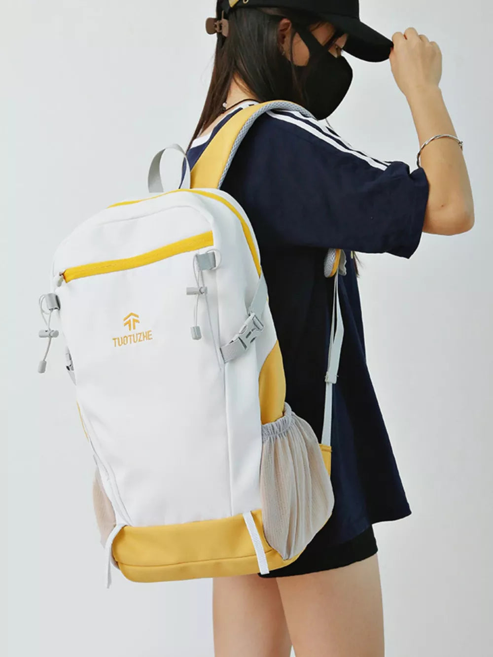 White and yellow nylon backpack with mesh side pockets and yellow trim