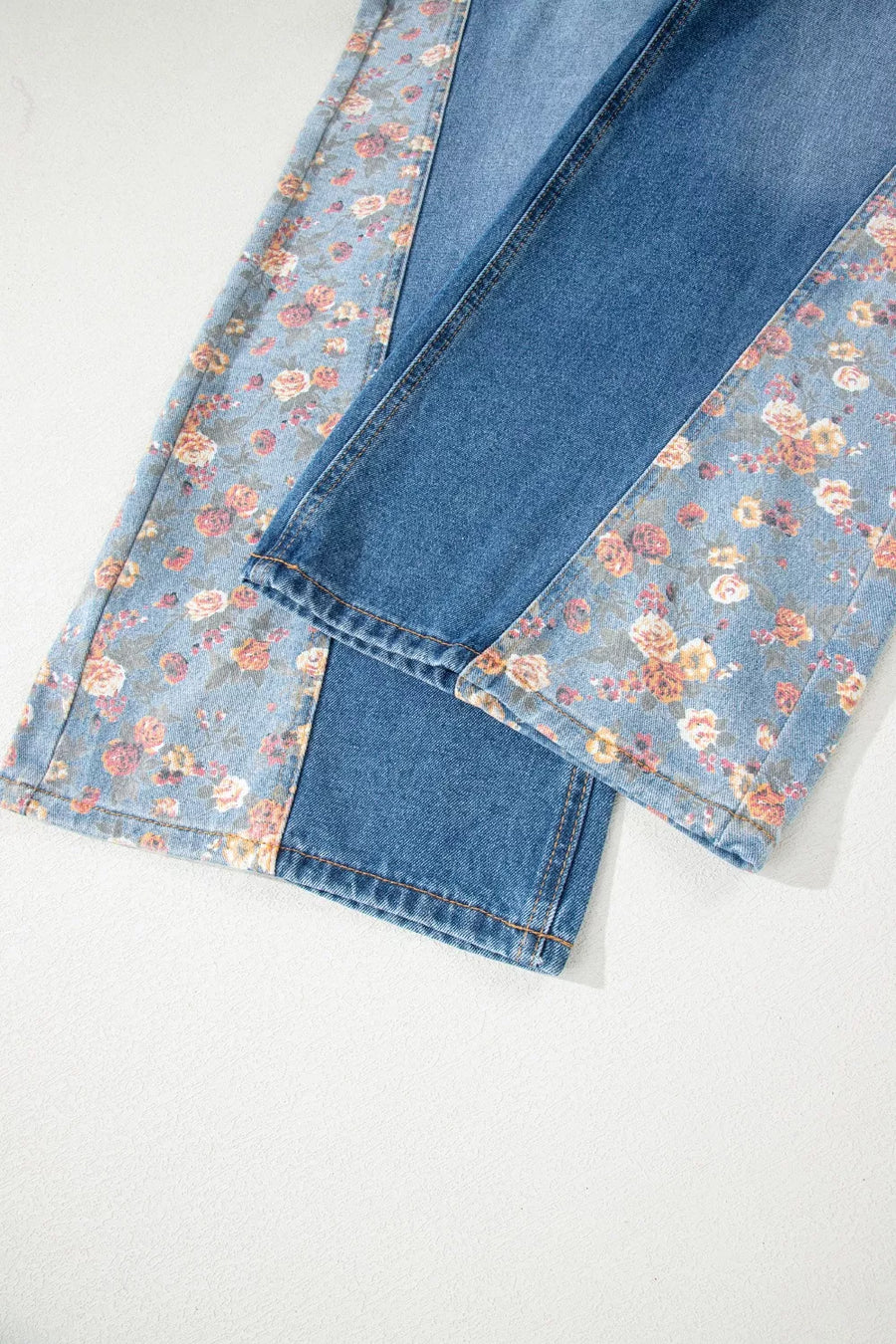 Denim overalls with vintage floral print panels and contrast stitching.
