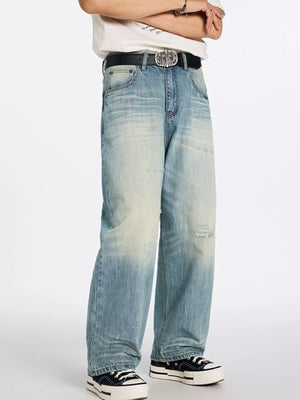 Men's relaxed wide-leg blue denim jeans with distressed details and a faded wash.