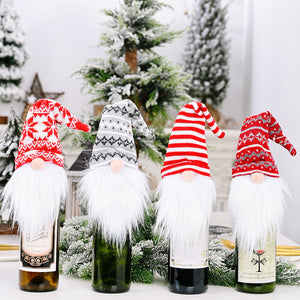 Festive gnome bottle toppers in red, white, and gray knit designs with white beards.