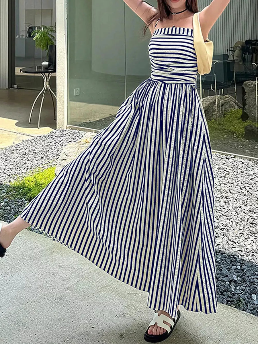 Navy and white striped maxi dress with spaghetti straps, cinched waist, and a thigh-high slit.