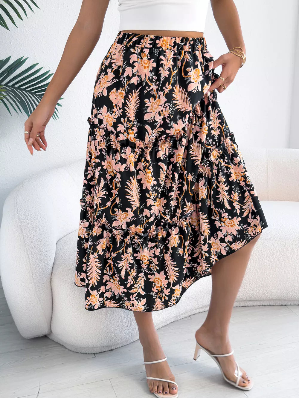 Black floral midi skirt with ruffle hem and tiered design.