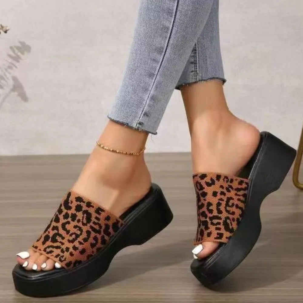 Platform knit slide sandals with leopard print and black sole.