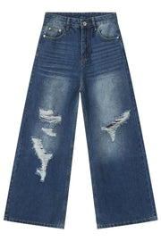 Distressed palazzo jeans in medium wash denim with wide legs and ripped details.