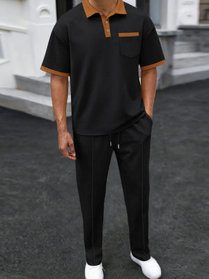 Black textured polo shirt with contrast collar and pocket, paired with matching track pants.
