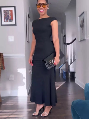 Black backless cap sleeve maxi gown with boat neckline and body-skimming cut.