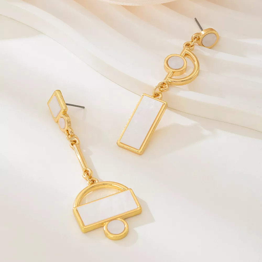 ivory earrings featuring drop design and geometric