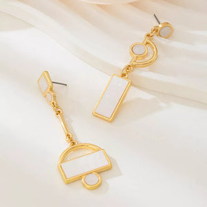 ivory earrings featuring drop design and geometric