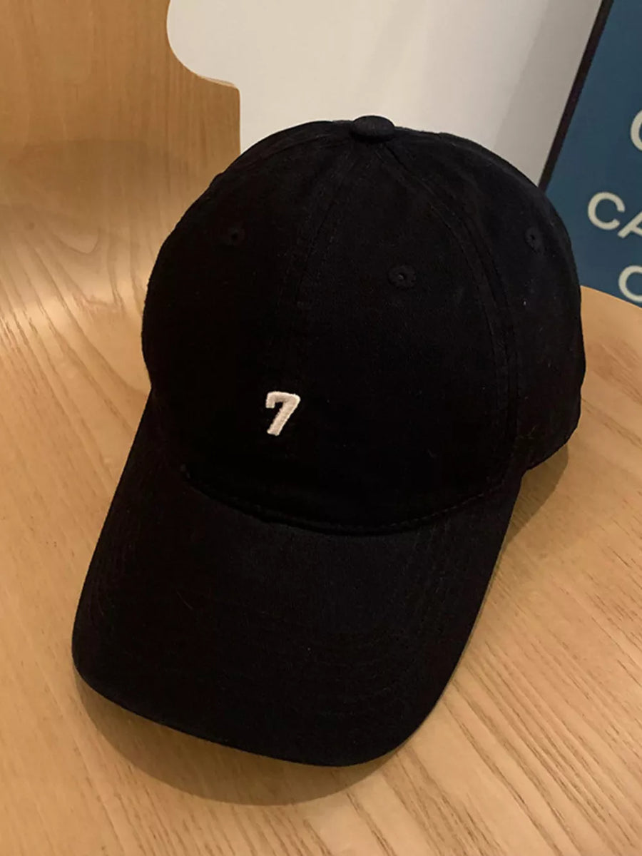 Black cotton baseball cap with embroidered white number 7 detail