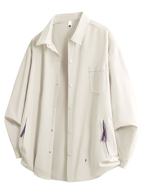 Cream long sleeve button-up shirt with chest pocket and purple accent details