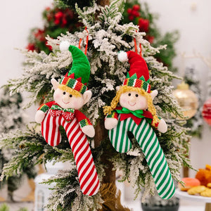 Elf cane holiday ornaments in red and green stripes with cheerful faces and hats.