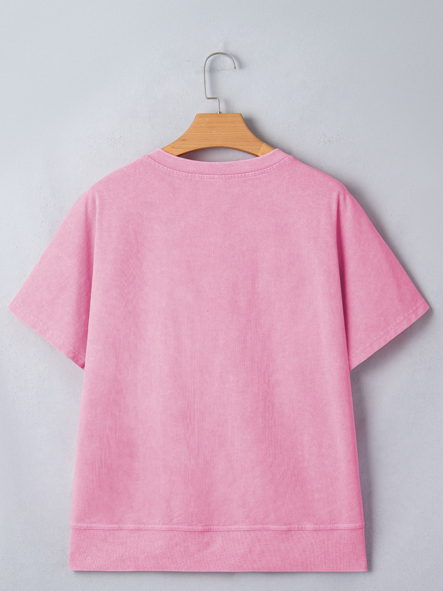 Pink mineral wash cotton t-shirt with short sleeves and a notched neckline.