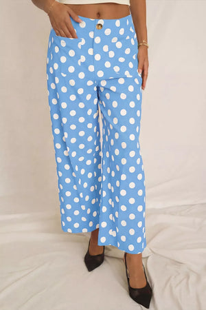 Blue polka dot cropped pants with pockets and a button closure.
