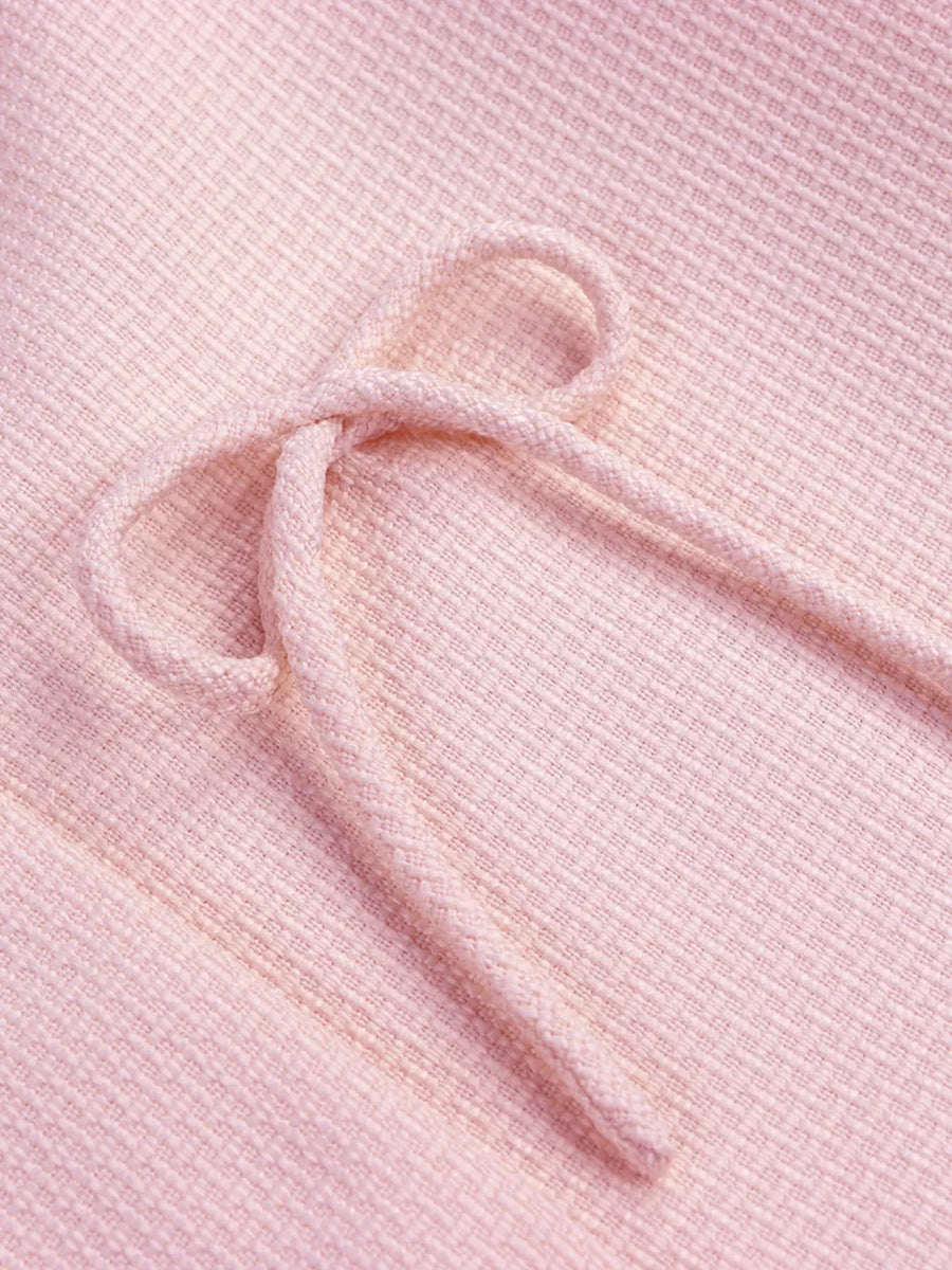 Pink textured knit top with drawstring detail