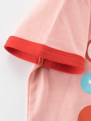 Pink t-shirt with red trim on short sleeves and a graphic print.